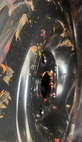 Wheel rim flecked with orange paint