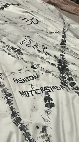 Close-up of painted lettering on the white fabric