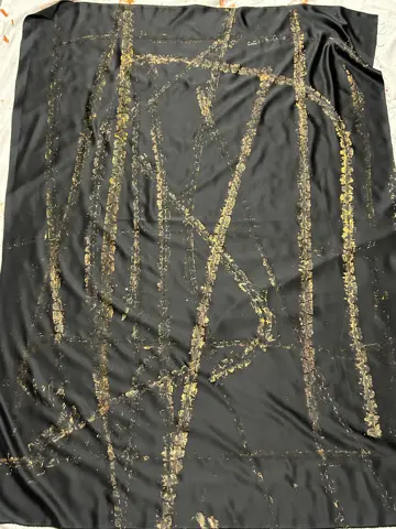 Gold tyre tracks printed on black fabric
