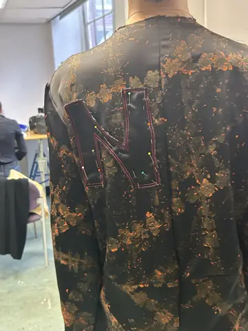 Back of jacket showing gold printed texture